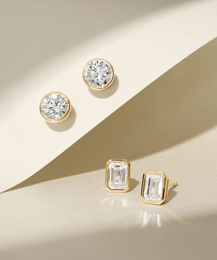 2 pairs of bezel set diamond earrings