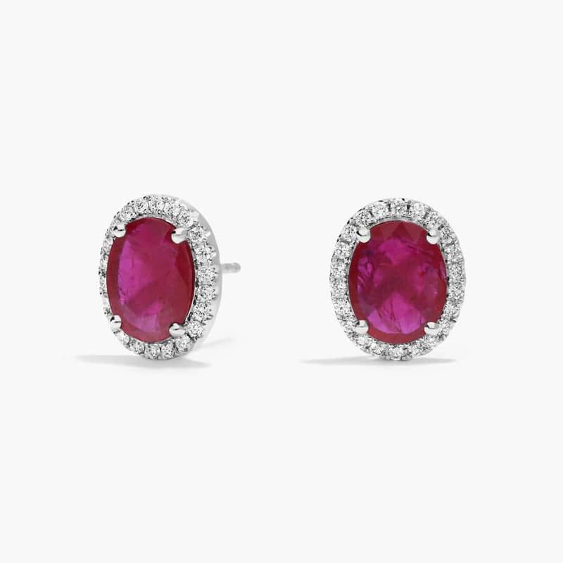 Oval Cut Ruby & Diamond Halo Stud Earrings with 0.2 CTW Round Cut Diamonds in 18K White Gold