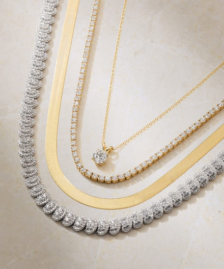 A diamond pendant, and tennis necklace stacked