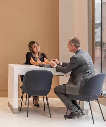 Blue Nile showroom representative presenting diamond engagement rings to customer