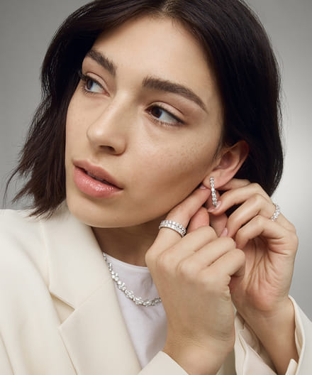 Model wearing diamond jewelry rings and necklaces